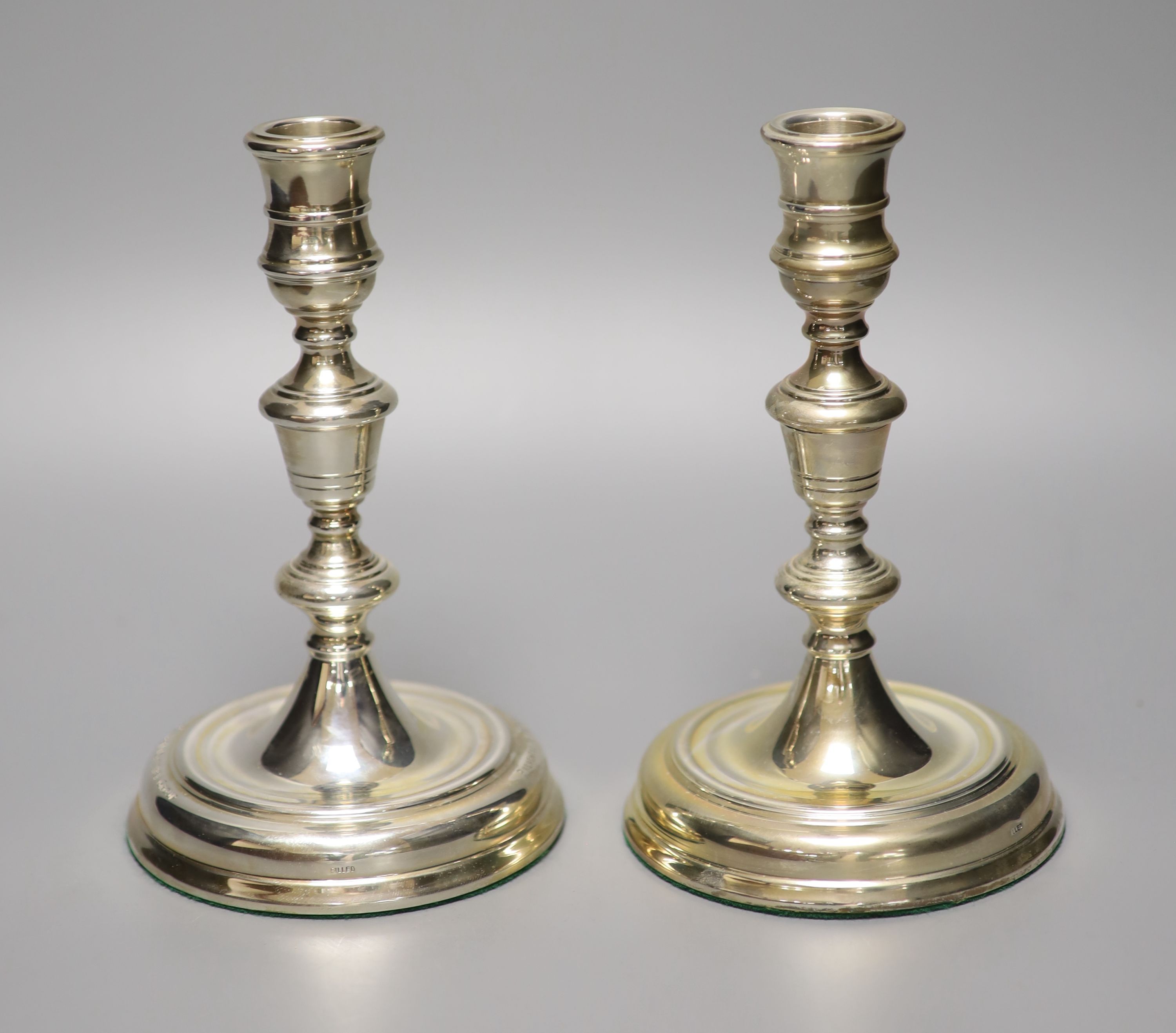 A pair of George II style silver presentation candlesticks, weighted, London 1986, David Shaw Silverware Ltd, in fitted case